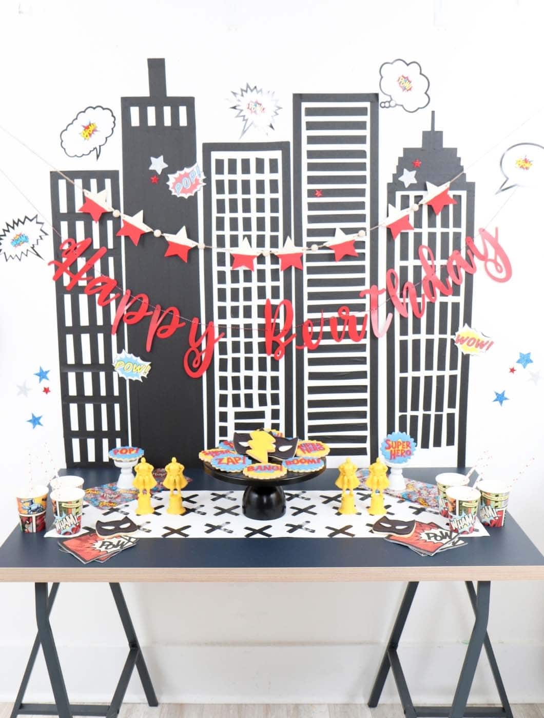 superhero party dessert table and backdrop