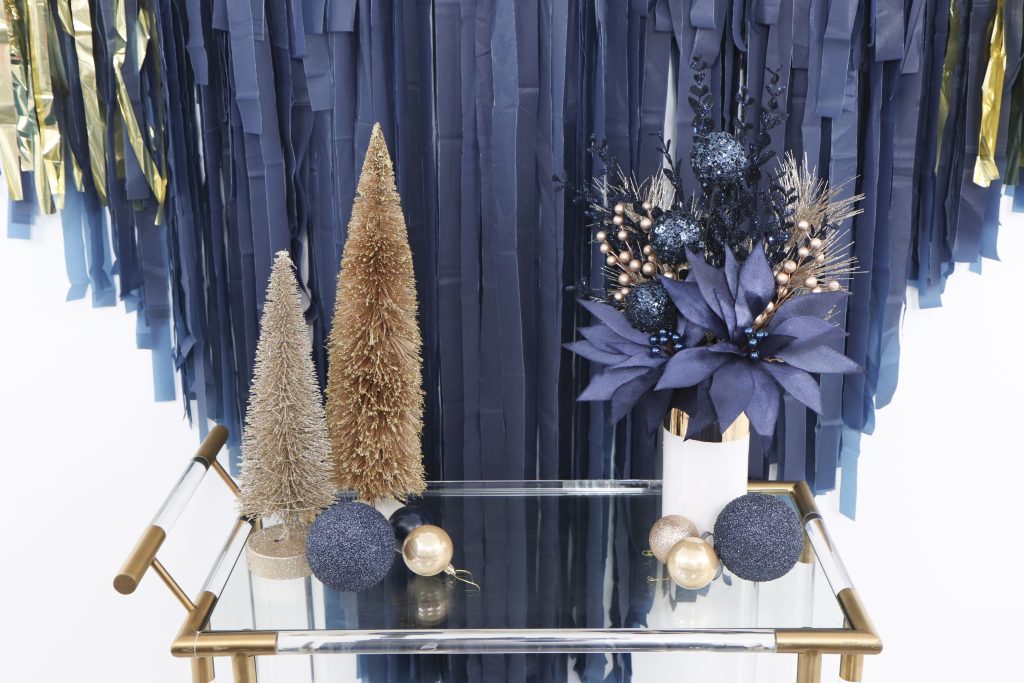 navy and gold holiday backdrop and bar cart