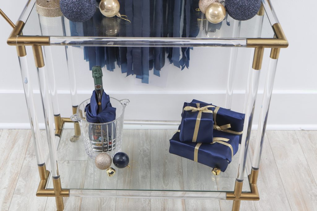 navy and gold holiday backdrop and bar cart