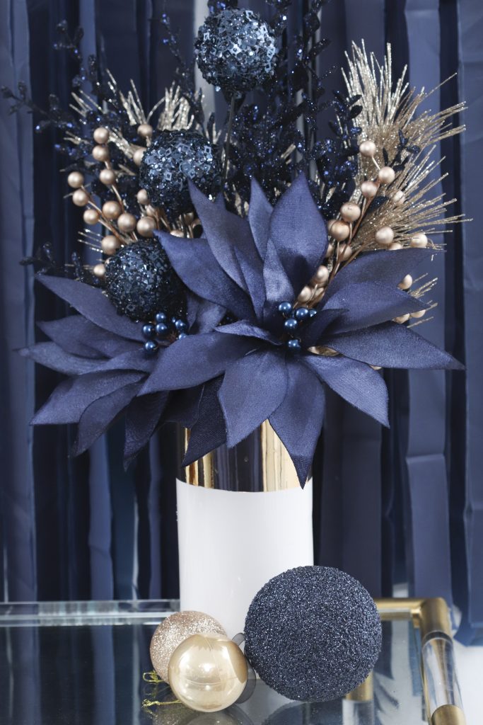 navy and gold holiday poinsettia floral arrangement