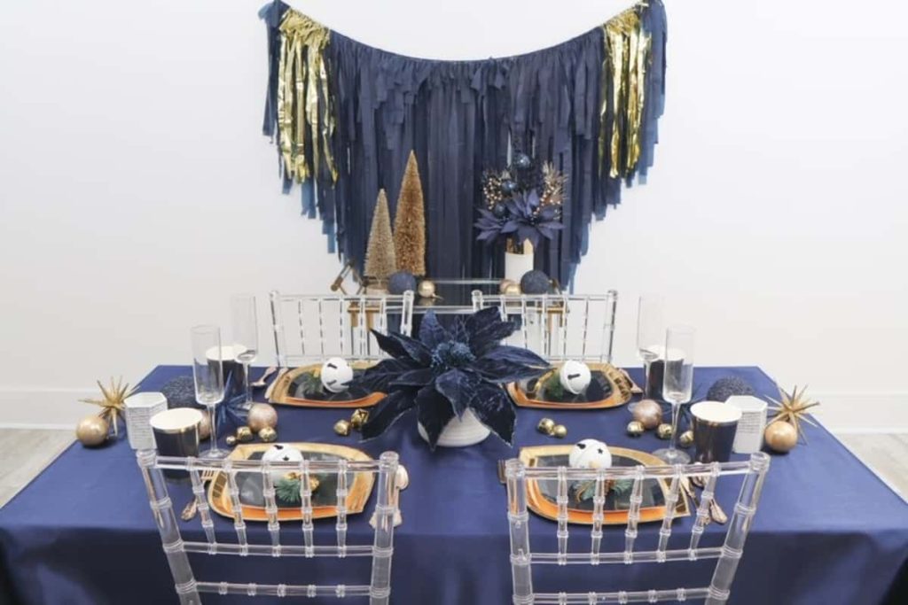 Christmas dinner table decorations in blues and gold following a