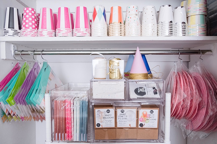 Maximize closet space for party supply organizing by using shower hooks to hang supplies! Get more organizing ideas now at fernandmaple.com.