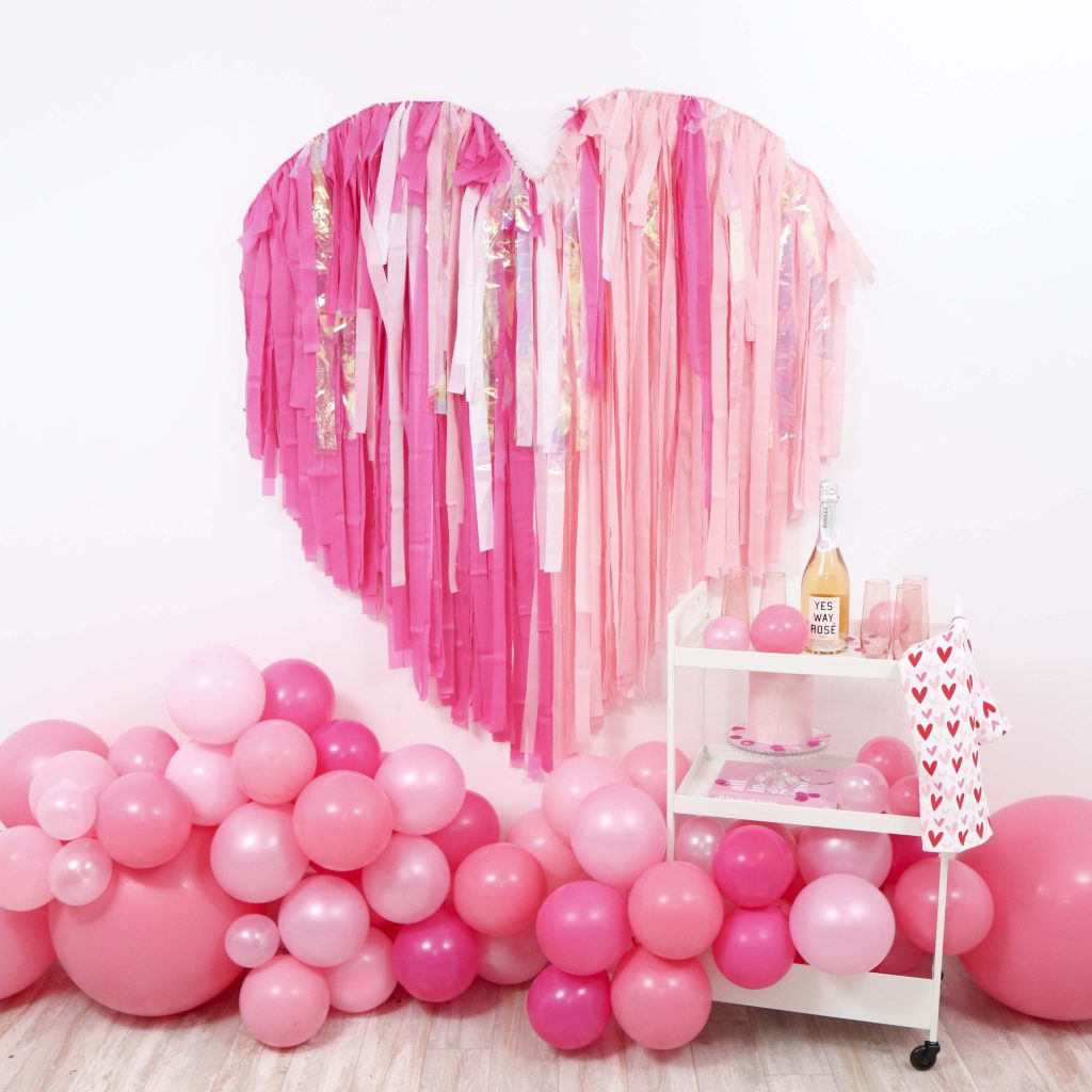 Create a show-stopping Valentine's Day backdrop for Instagram-worthy photo ops with this Valentine's Day Fringe Heart Backdrop! Get details now at fernandmaple.com!