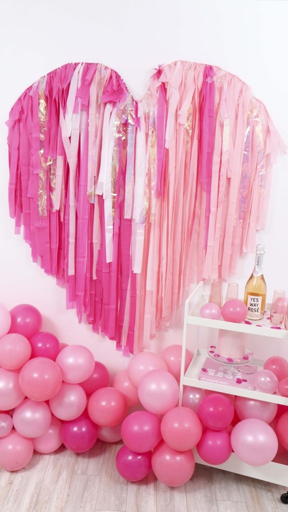 Create a show-stopping Valentine's Day backdrop for Instagram-worthy photo ops with this Valentine's Day Fringe Heart Backdrop! Get details now at fernandmaple.com!