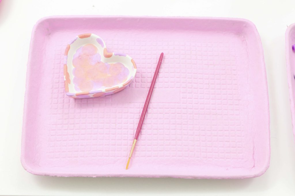 Valentine's crafts for a Valentine's Day Craft Party for Kids with fringe heart backdrop, craft cart, and craft table ideas! Get all of the details now at fernandmaple.com!