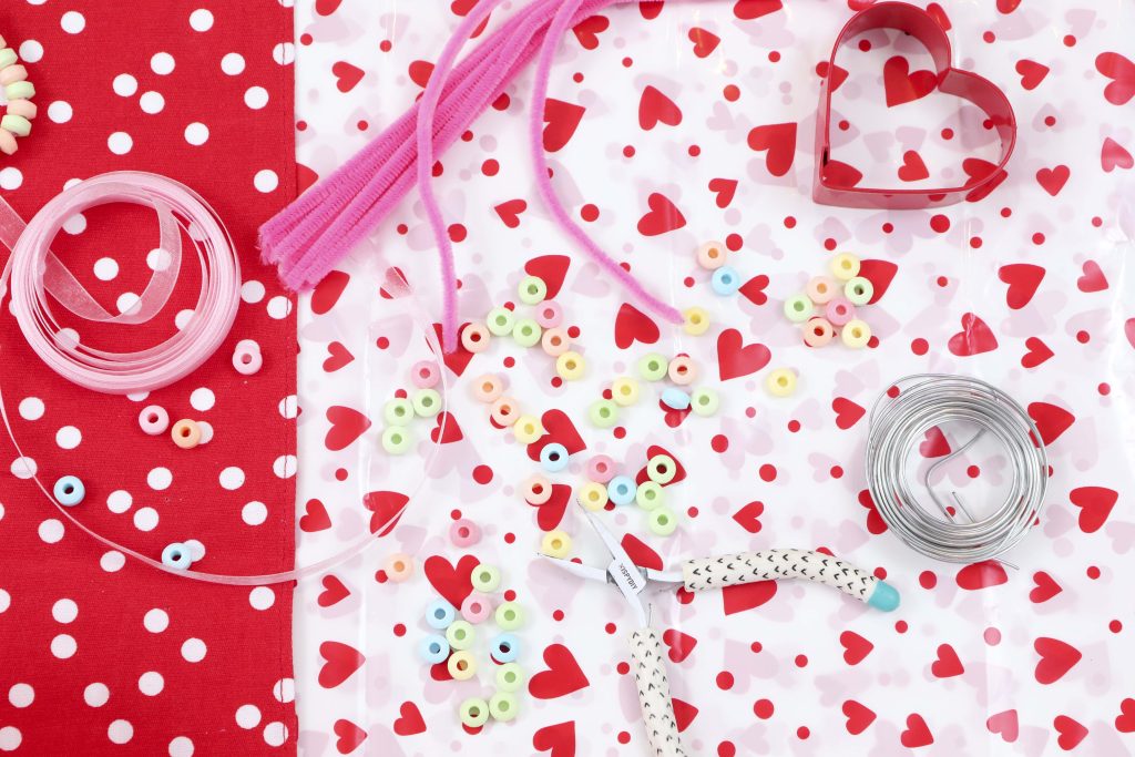 Create cute and edible Valentine's Day Candy Heart Ornaments with kids to hang on a tree or around the house, give as gifts, or treat yourself! Get instructions now at fernandmaple.com!