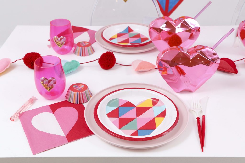 Colorful and modern Geometric Heart Valentine's Day Party table settings - Get details and more party ideas now at fernandmaple.com!