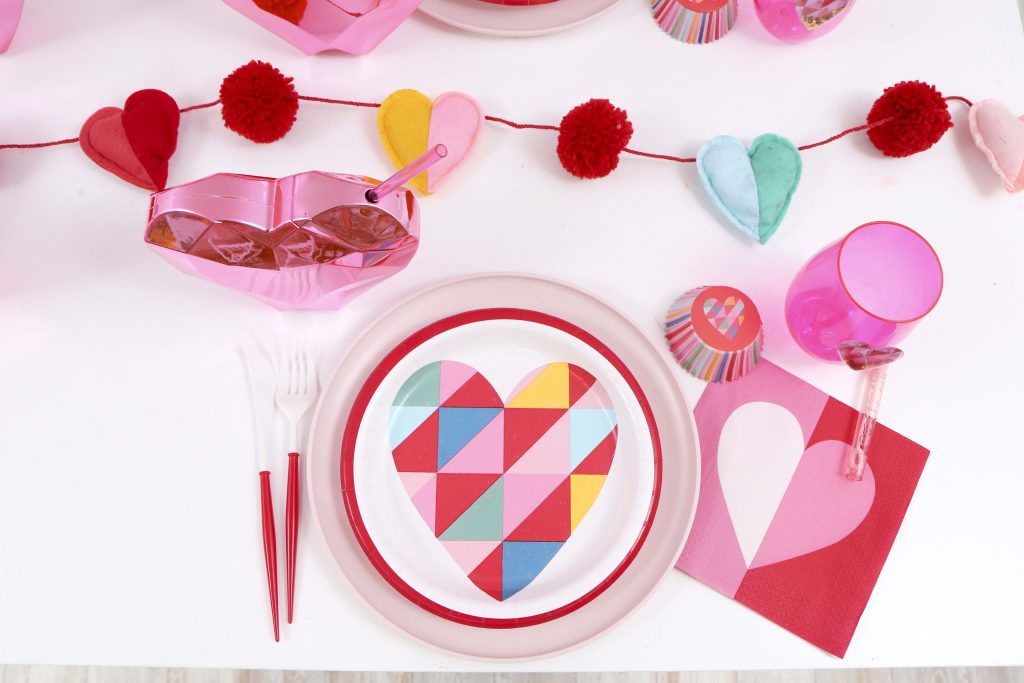 Colorful and modern Geometric Heart Valentine's Day Party table settings - Get details and more party ideas now at fernandmaple.com!