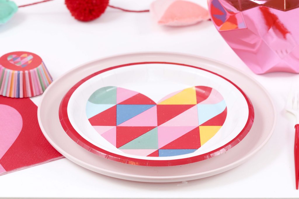 Colorful and modern Geometric Heart Valentine's Day Party table settings - Get details and more party ideas now at fernandmaple.com!