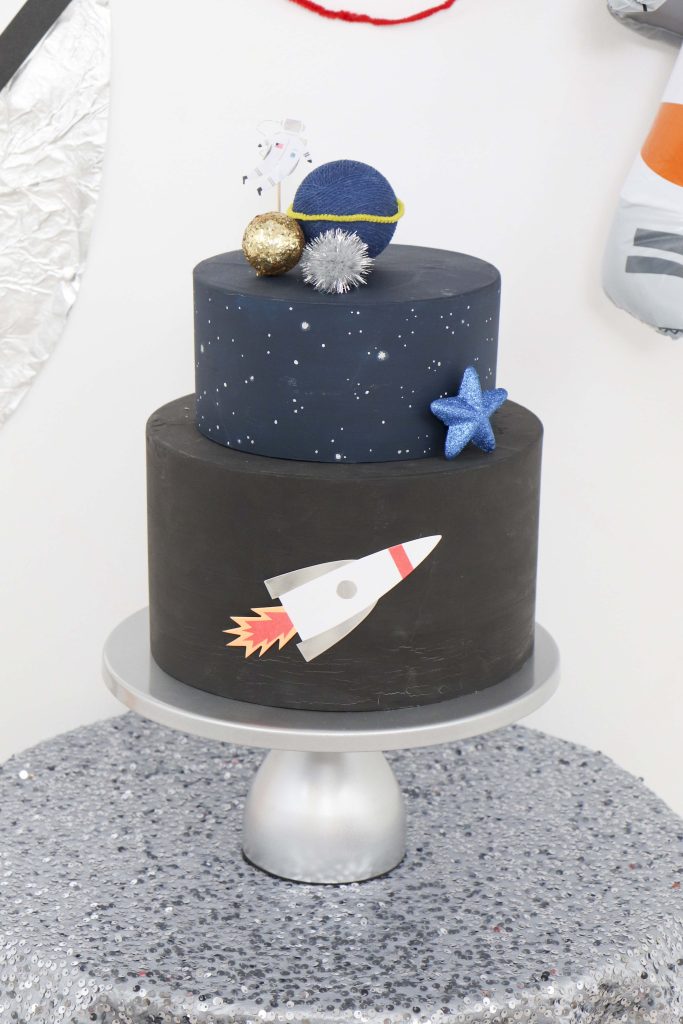 Space Party Cake Idea - Looking to throw a Space or Rocket themed birthday? Check out this game-changing “party in a box” recommendation as well as tips for personalizing the party! Get details now at fernandmaple.com.