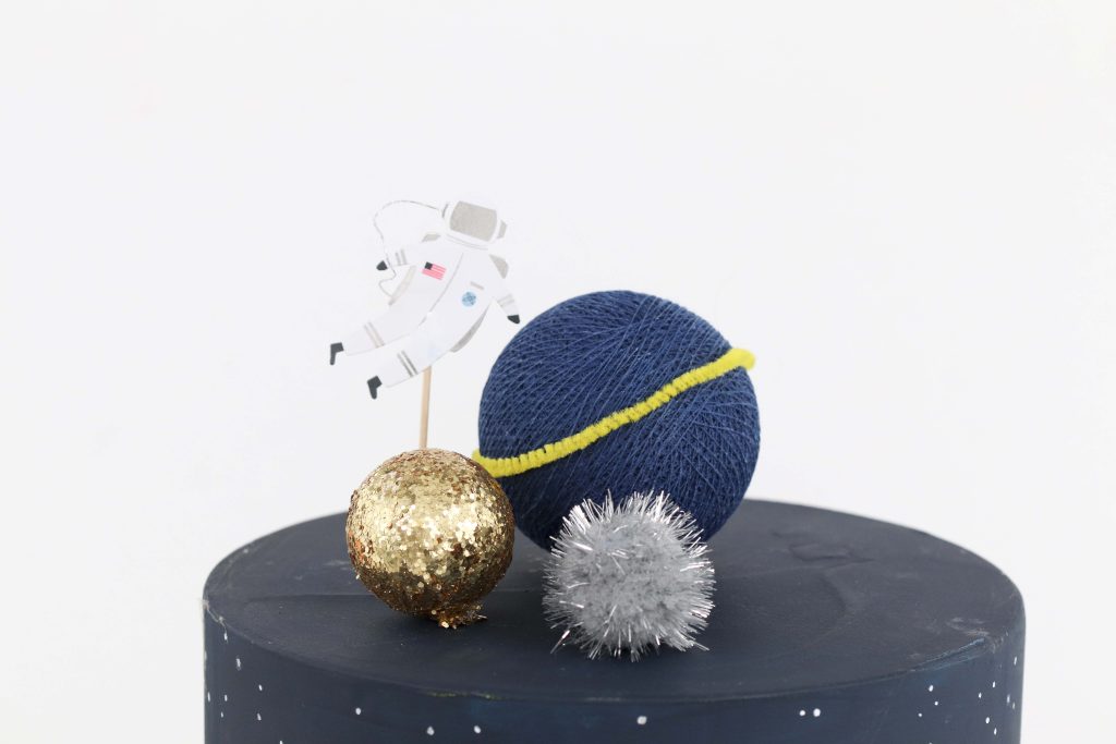 Space Party Cake Topper - Looking to throw a Space or Rocket themed birthday? Check out this game-changing “party in a box” recommendation as well as tips for personalizing the party! Get details now at fernandmaple.com.