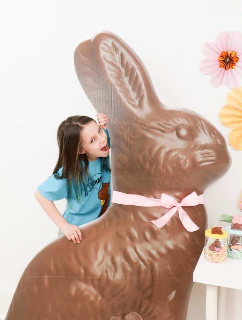 Giant Chocolate Bunny Easter Stand, perfect for photo ops - get more Chocolate Bunny Easter Party inspiration now at fernandmaple.com!