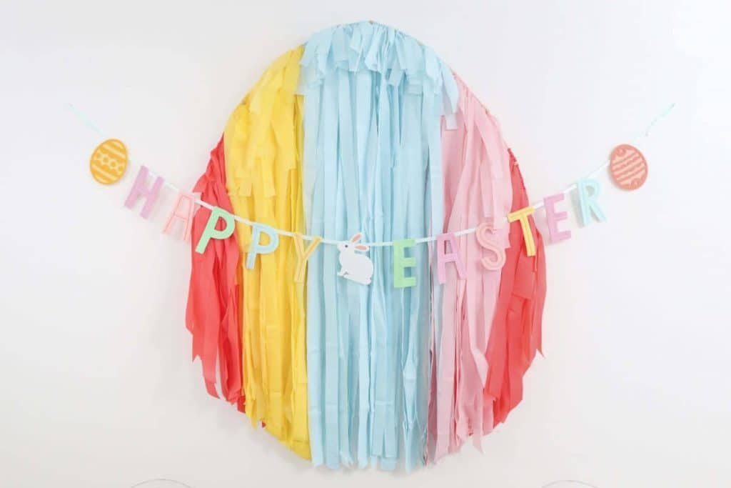 Easter Egg Fringe Backdrop - Get details and more Easter party inspiration now at fernandmaple.com!