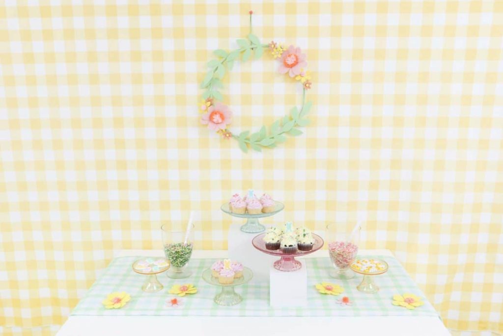 Spring Dessert Table with yellow gingham backdrop and felt floral wreath - get more Spring Party inspiration now at fernandmaple.com!