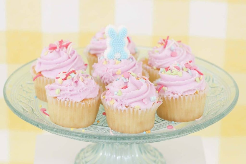 Pastel pink Easter cupcakes on a pale blue stand - get more Spring Party inspiration now at fernandmaple.com!