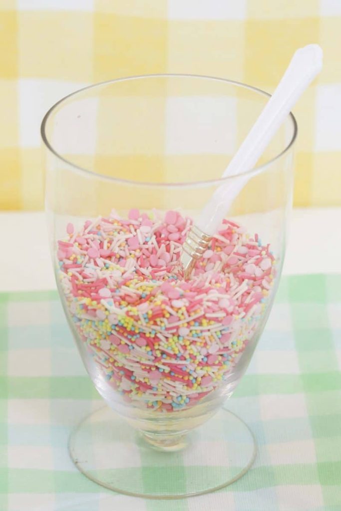 Jar of Spring sprinkles for a Spring Gingerbread House decorating party - get more Spring Party inspiration now at fernandmaple.com!