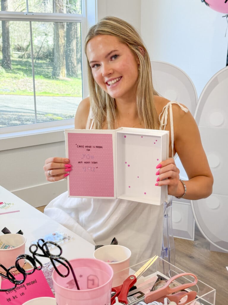 teen girls decorating inside senior year memory boxes with quotes at graduation party craft station