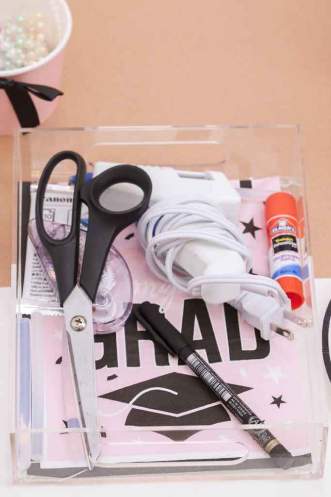 individual graduation party craft station place setting with acrylic tray, supplies and pink grad napkin