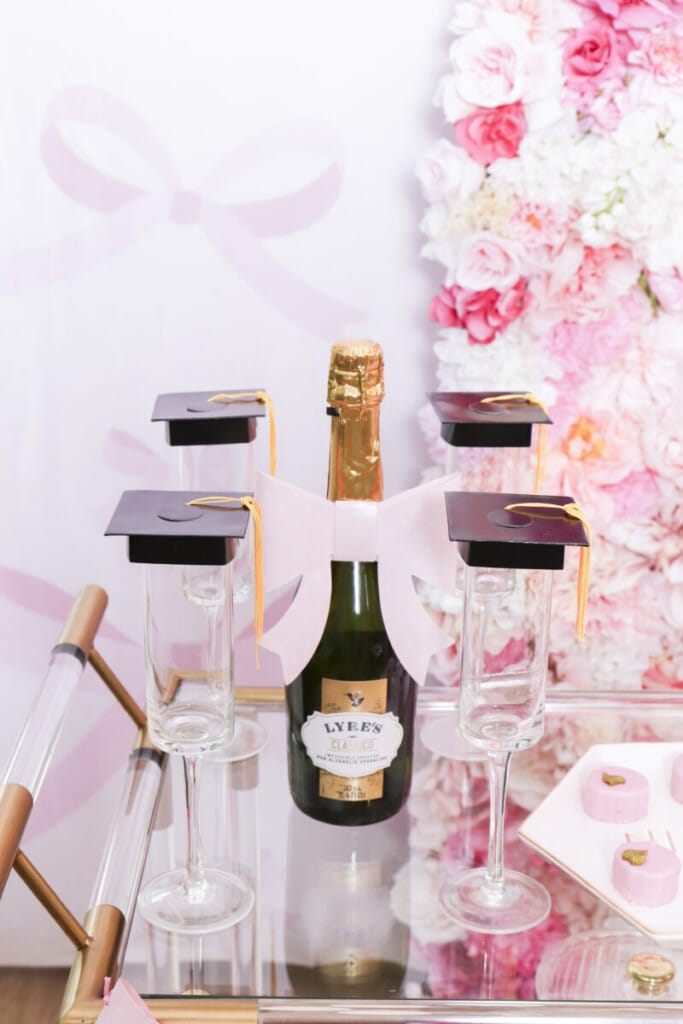 mini graduation caps on champagne glasses
