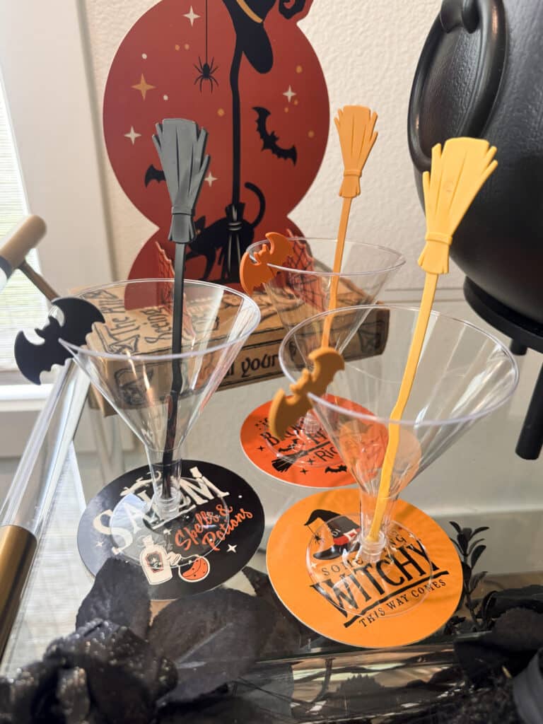 Halloween cocktail kit with broomstick stirrers, bat drink markers and themed coasters