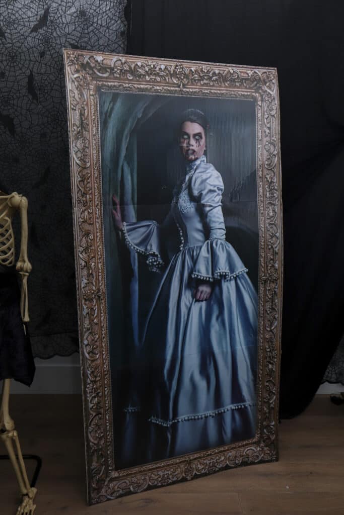 Large stand-up holographic portraits for a gothic Halloween paint and sip party