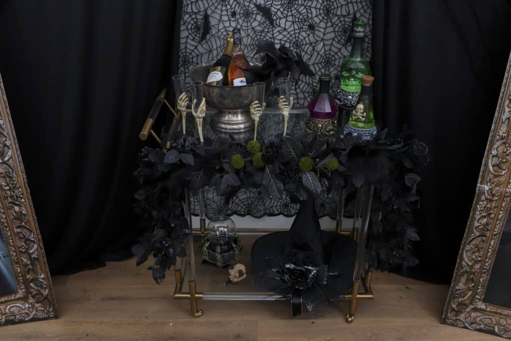 Potion bar cart setup for a gothic Halloween paint and sip party - drinks and styling