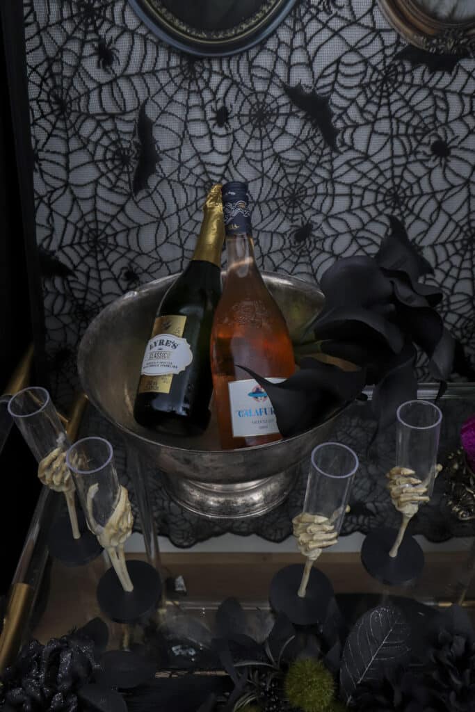 Potion bar cart setup for a gothic Halloween paint and sip party