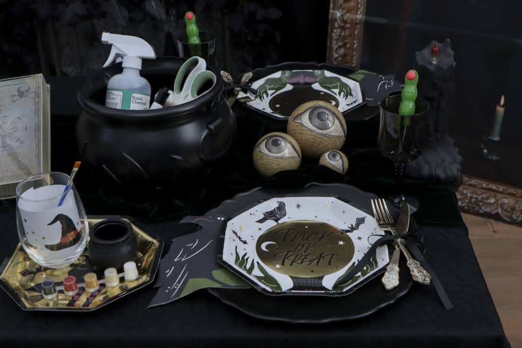 Individual glass painting stations set up for a gothic paint and sip party"