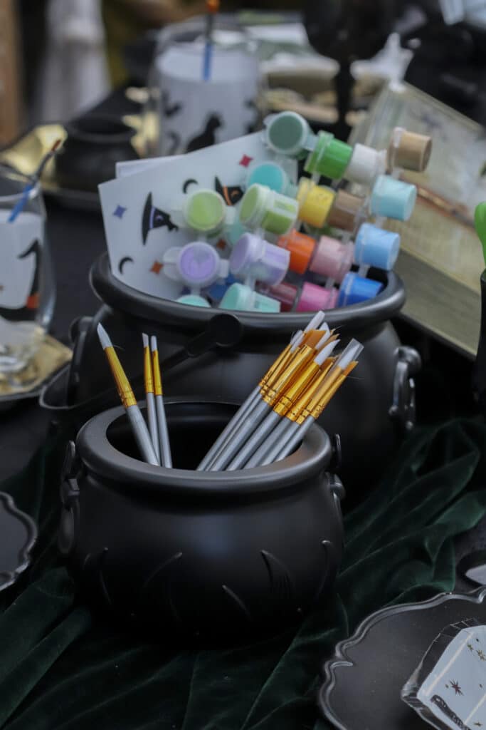 Gothic paint and sip party supplies including additional paintbrushes and colors in paint pots