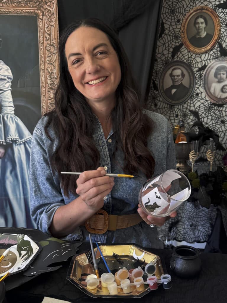 Painting a wine glass at a gothic paint and sip party"