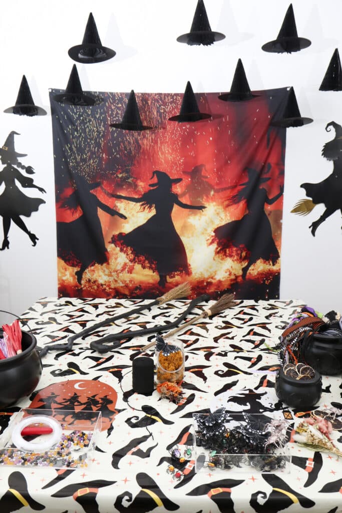 Practical Magic party ideas — broom making station and trays of smaller decorating supplies