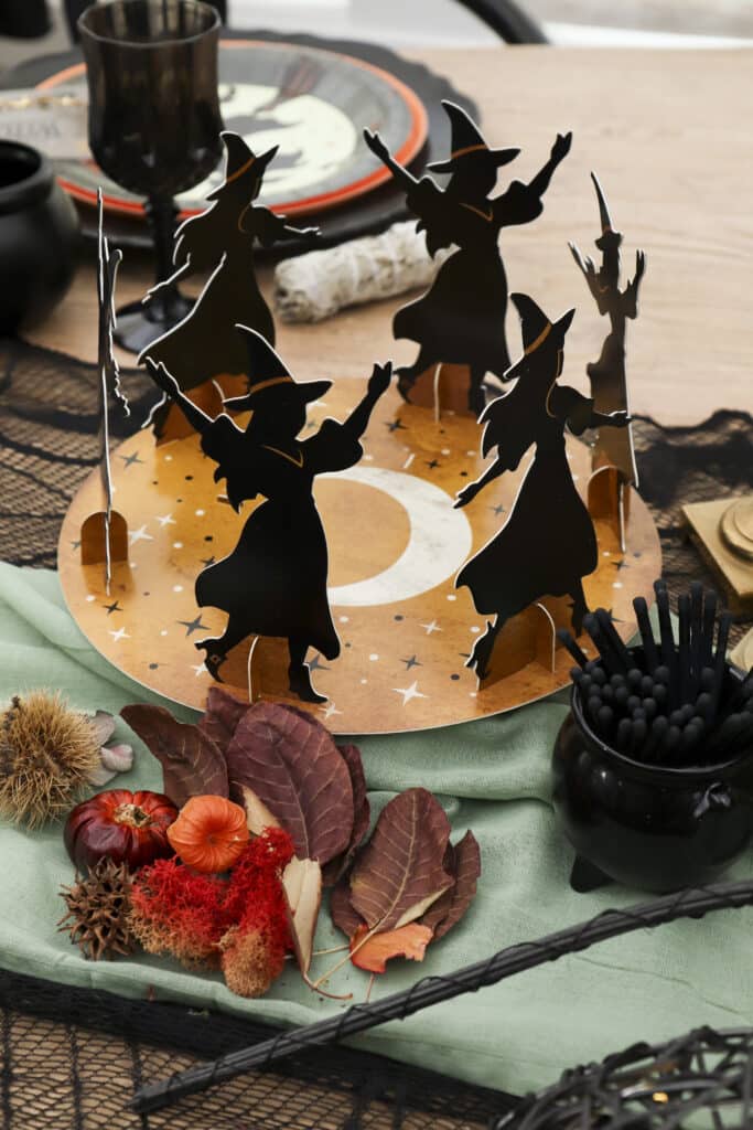 witch party centrepiece of witches around a salt circle