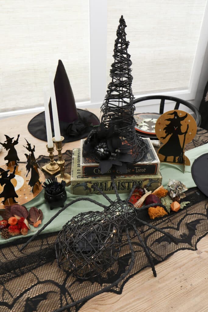 witch party table spell book and witch hat centrepiece