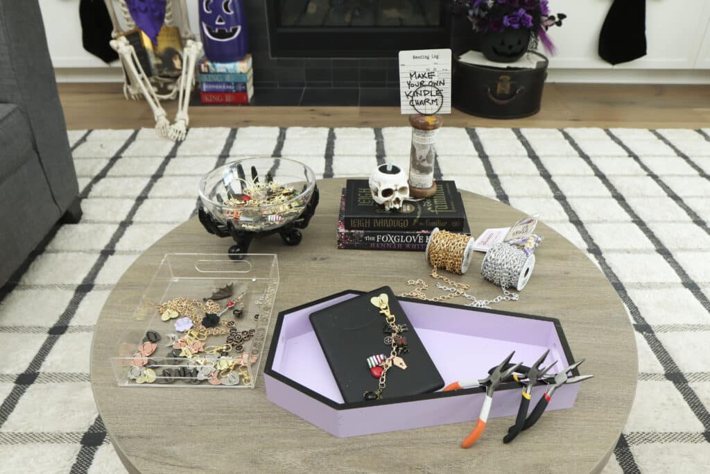 DIY dragon Kindle charm station on a coffee table for a dark romantasy book club party