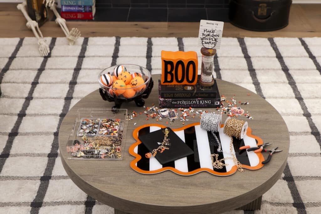 DIY Kindle charm station on a coffee table for a spooky book club party